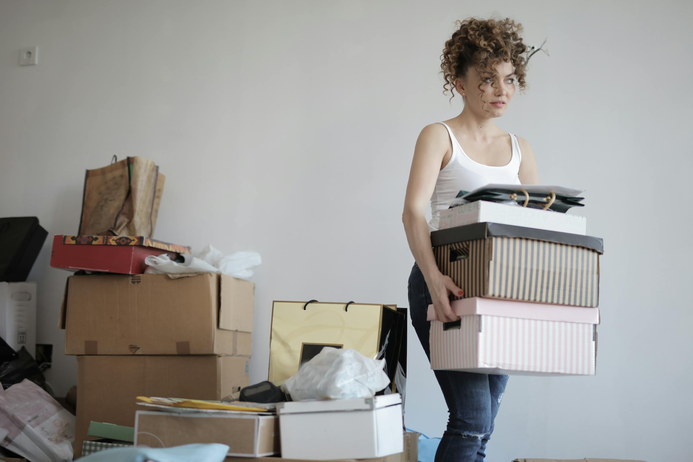 A woman carrying boxes for moving | Source: Pexels