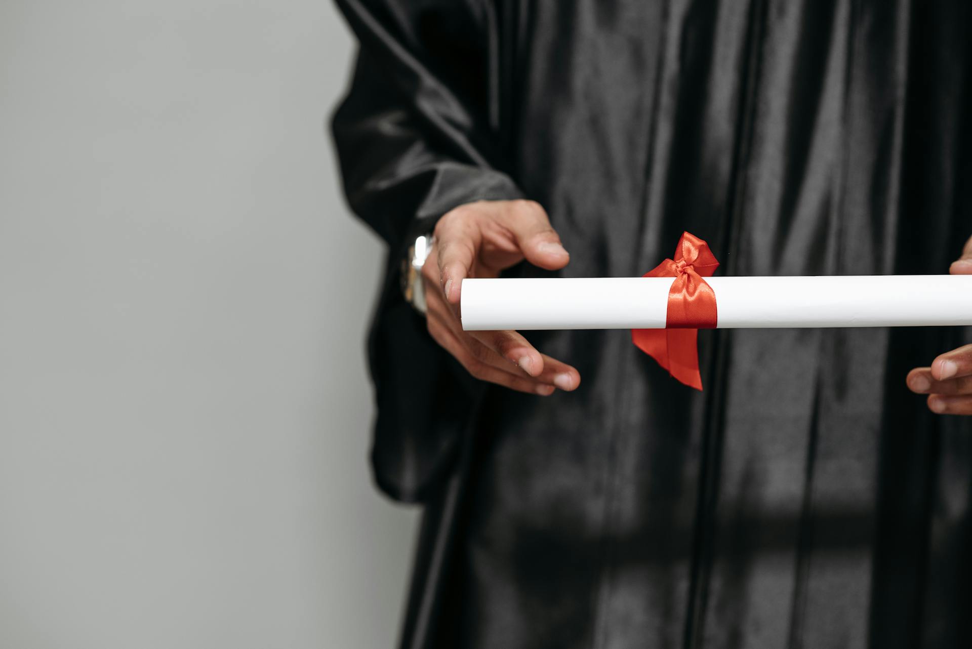 A person holding out a diploma | Source: Pexels