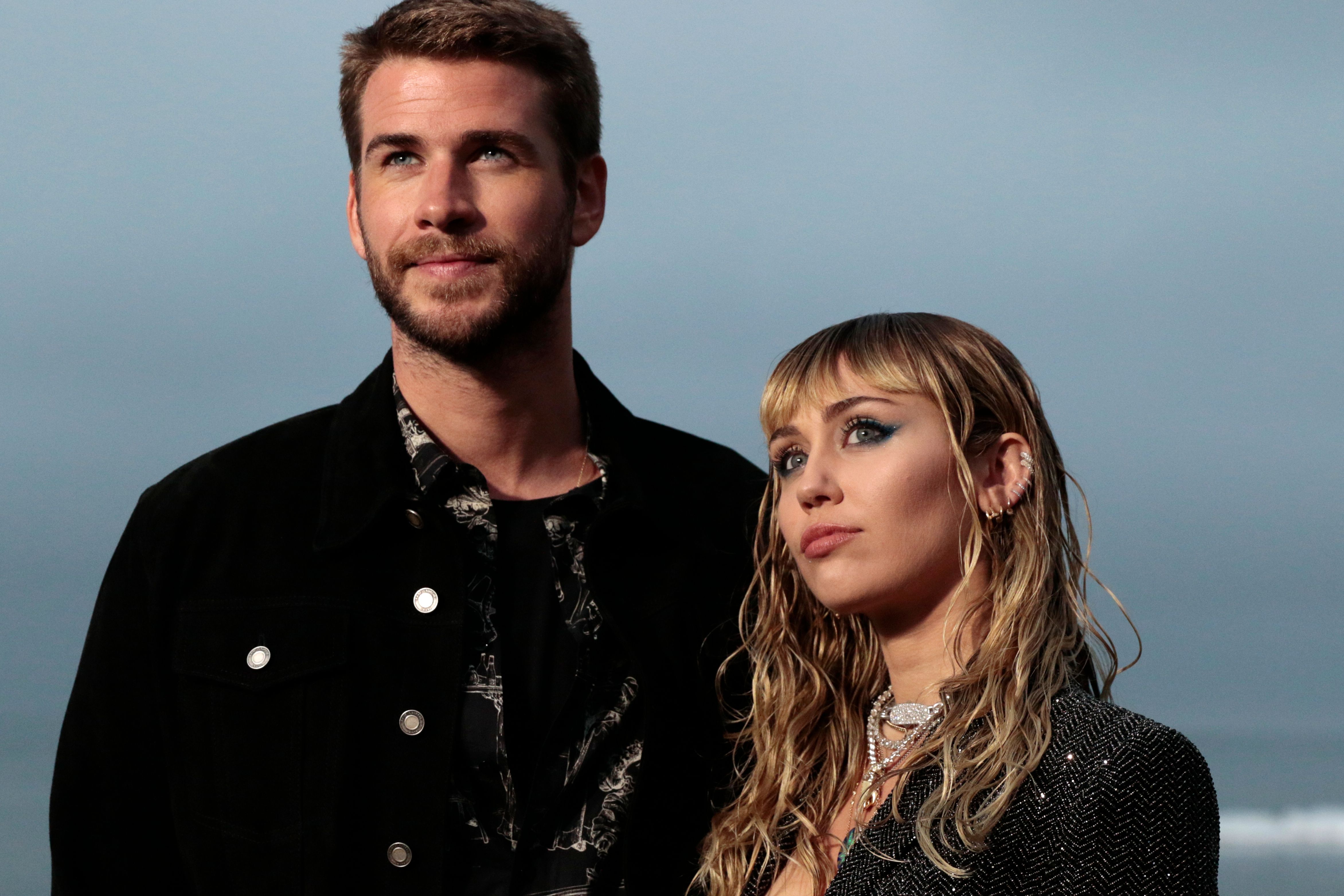 Miley Cyrus and husband Australian actor Liam Hemsworth arrive for the Saint Laurent Men's Spring-Summer 2020 runway show in Malibu, California, on June 6, 2019. | Source: Getty Images