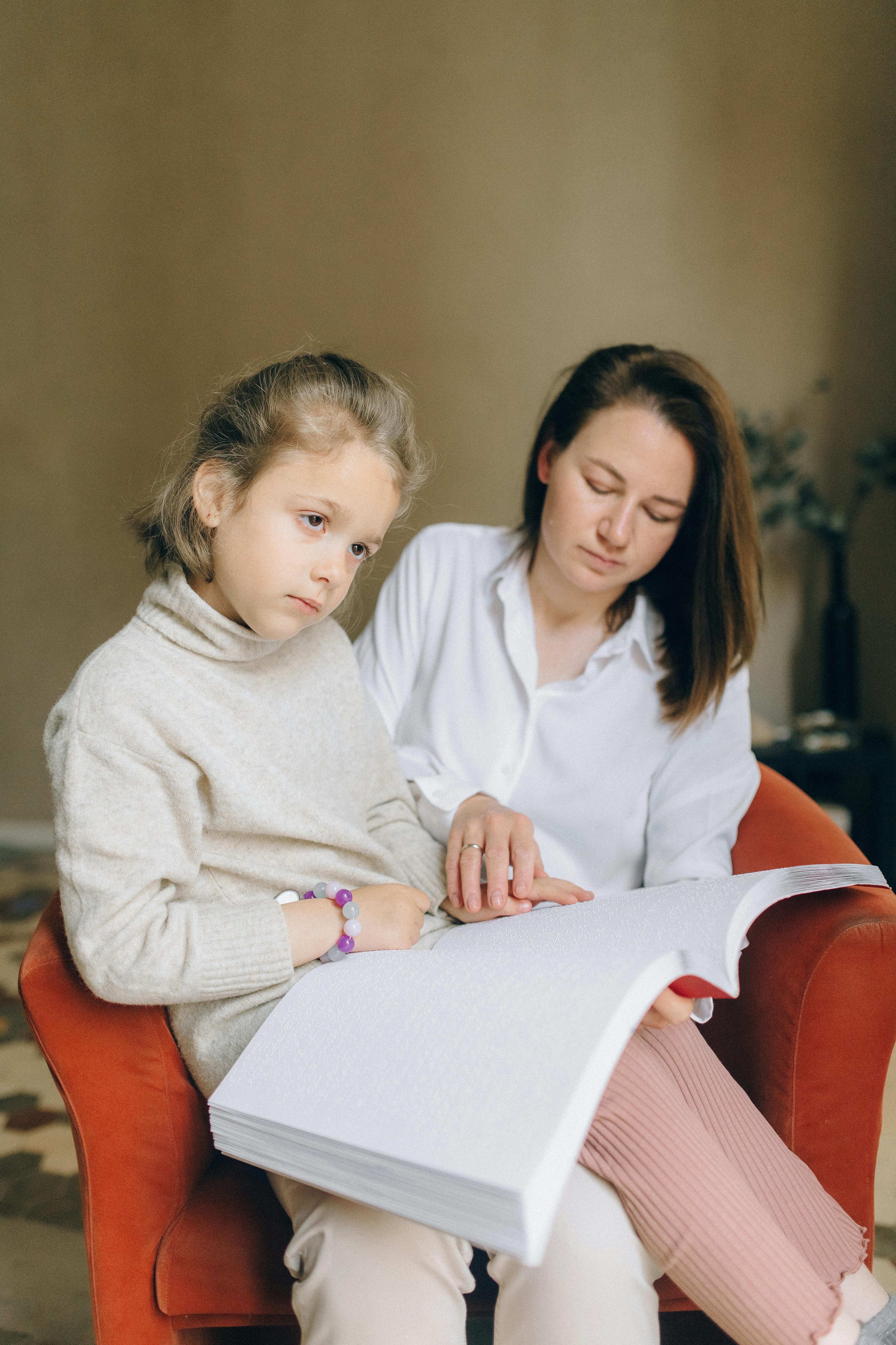 A woman helping her child to read | Source: Pexels