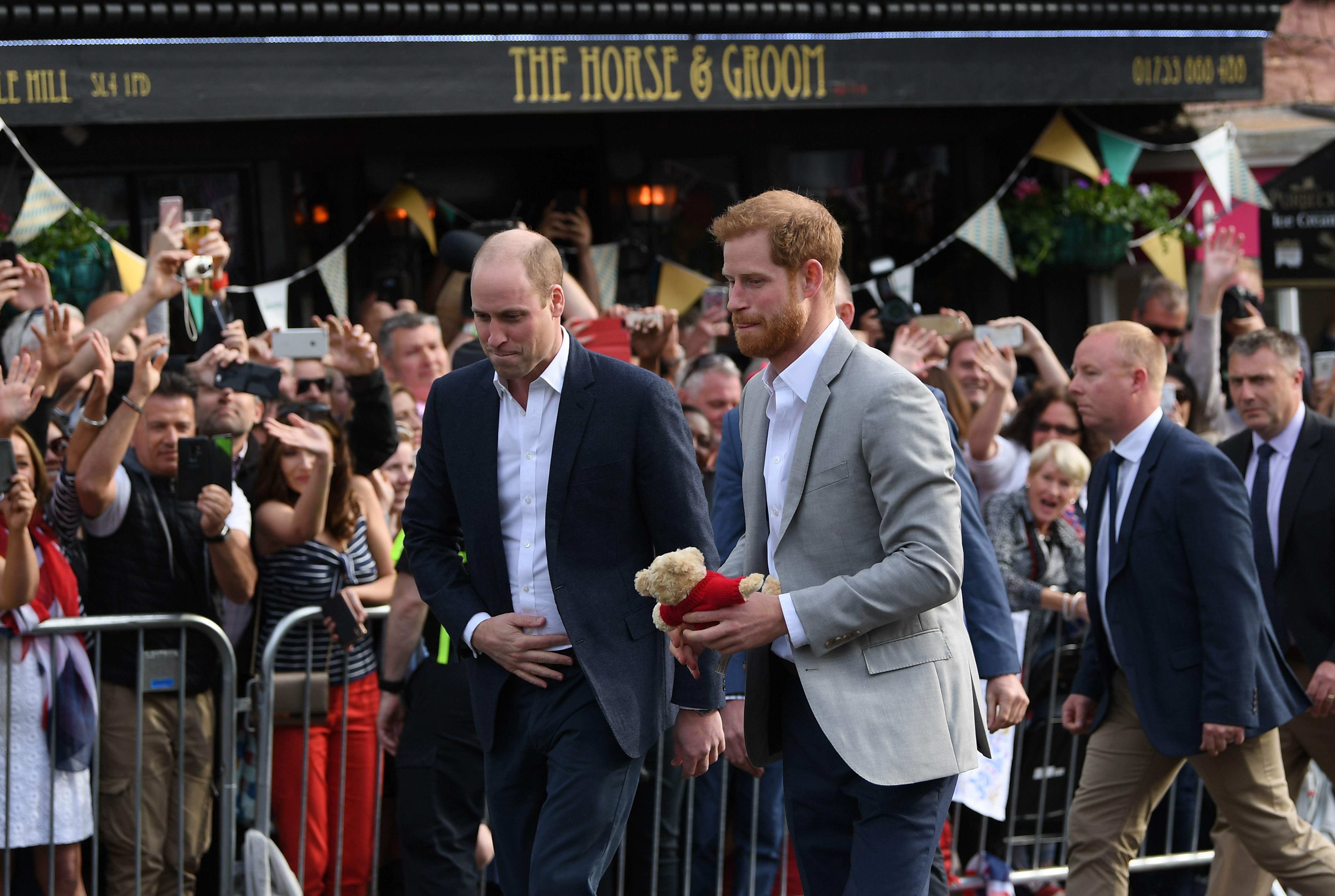 Prince Harry and Prince William, Duke of Cambridge embark on a walkabout ahead of the royal wedding of Prince Harry and Meghan Markle on May 18, 2018 in Windsor, England. | Source: Getty Images
