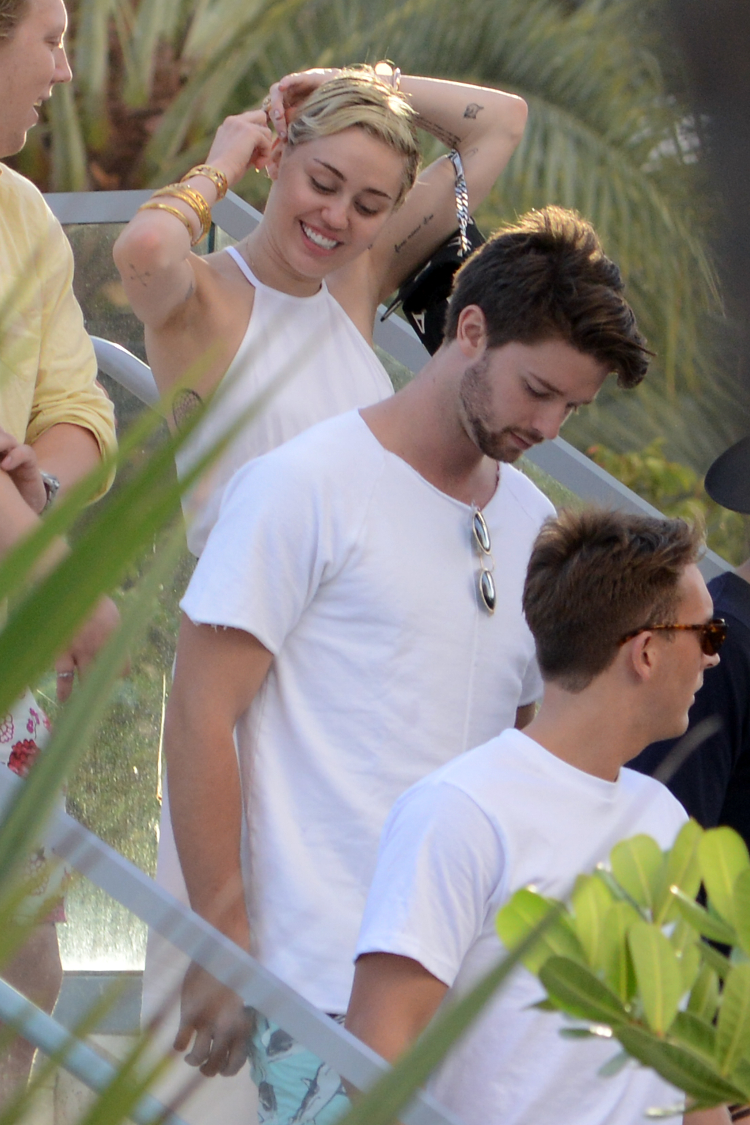 Patrick Schwarzenegger and Miley Cyrus is sighted at La Cote in the Fontainebleau Miami Beach Florida on December 5, 2014 in Miami, Florida. | Source: Getty Images