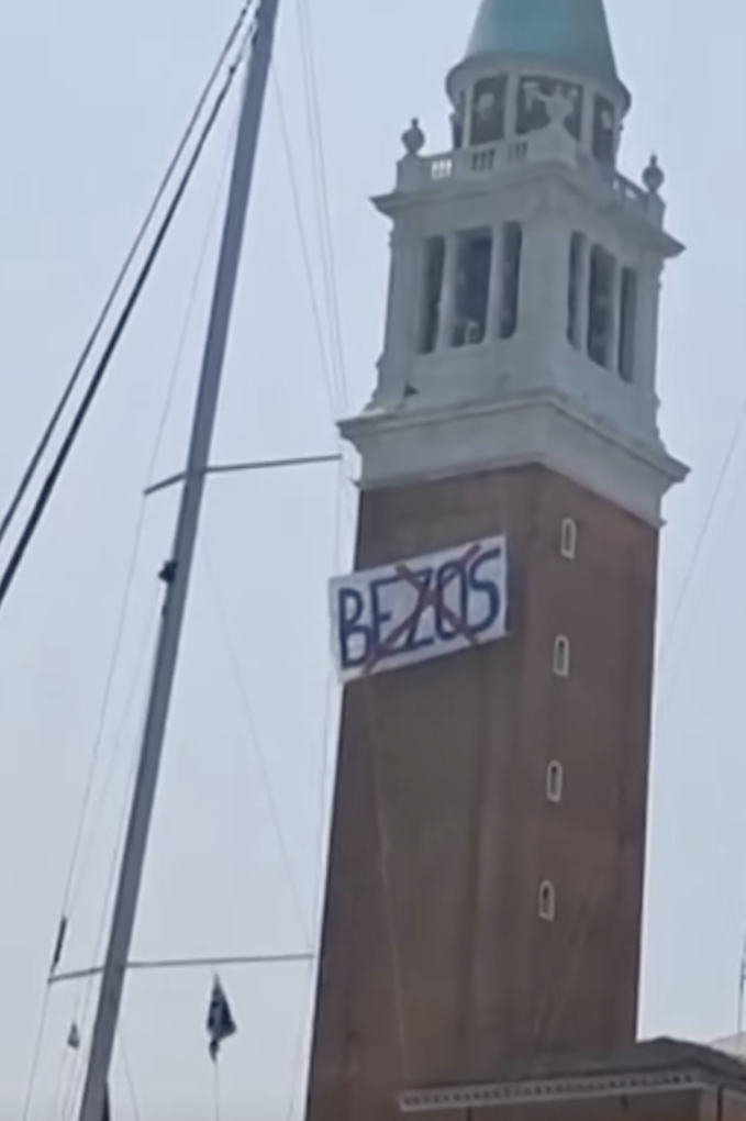 A poster hung on one of the building structures in Venice, Italy, posted on June 12, 2025 | Source: YouTube/Reuters