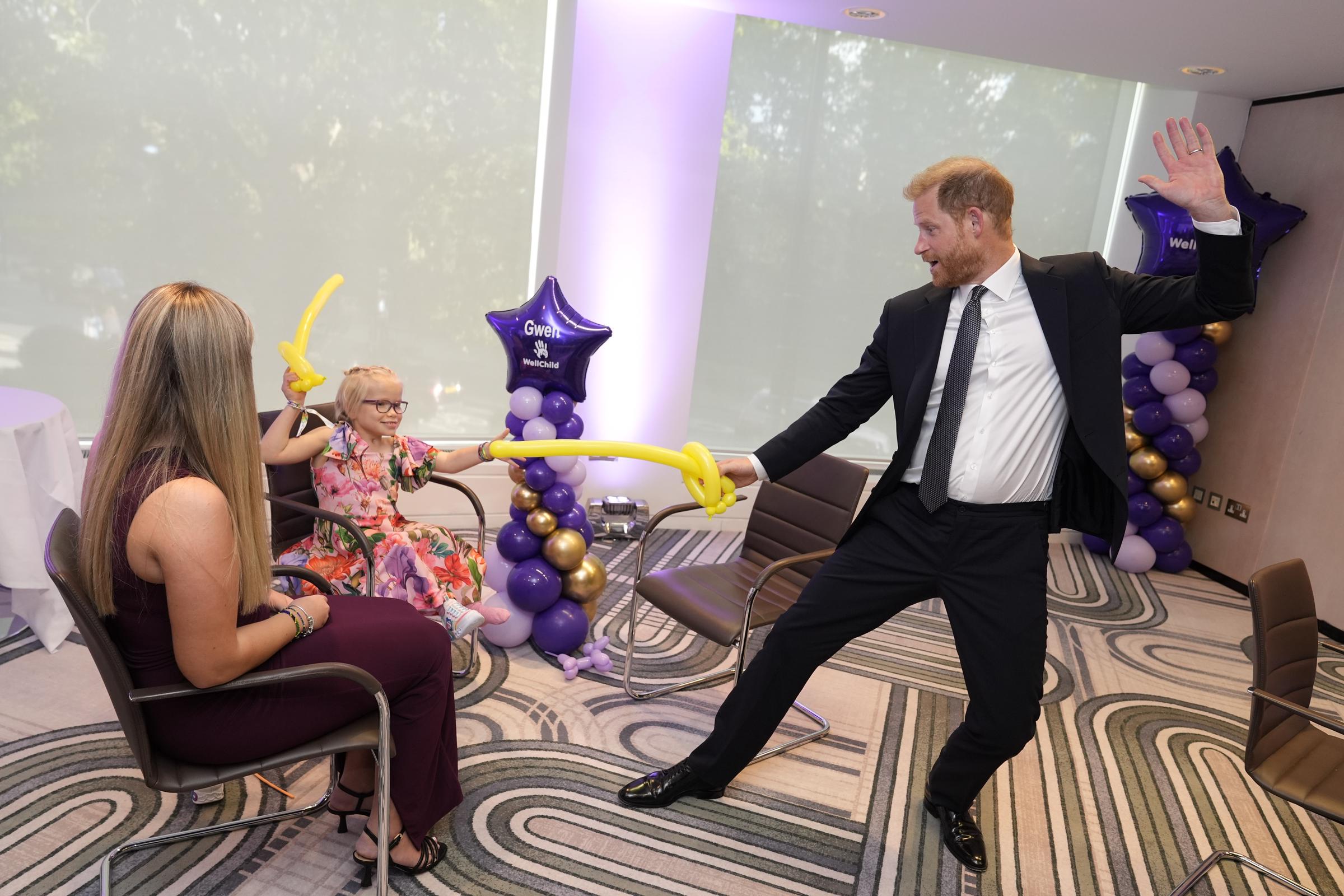 Prince Harry, Duke of Sussex, play fights using swords made from modelling balloons with nine-year-old Gwen Foster, recipient of Inspirational Child 7-11 award, at the annual WellChild Awards 2025, which celebrates the achievements and resilience of seriously ill youngsters and their families, at the Royal Lancaster Hotel on September 8, 2025, in London, England. | Source: Getty Images