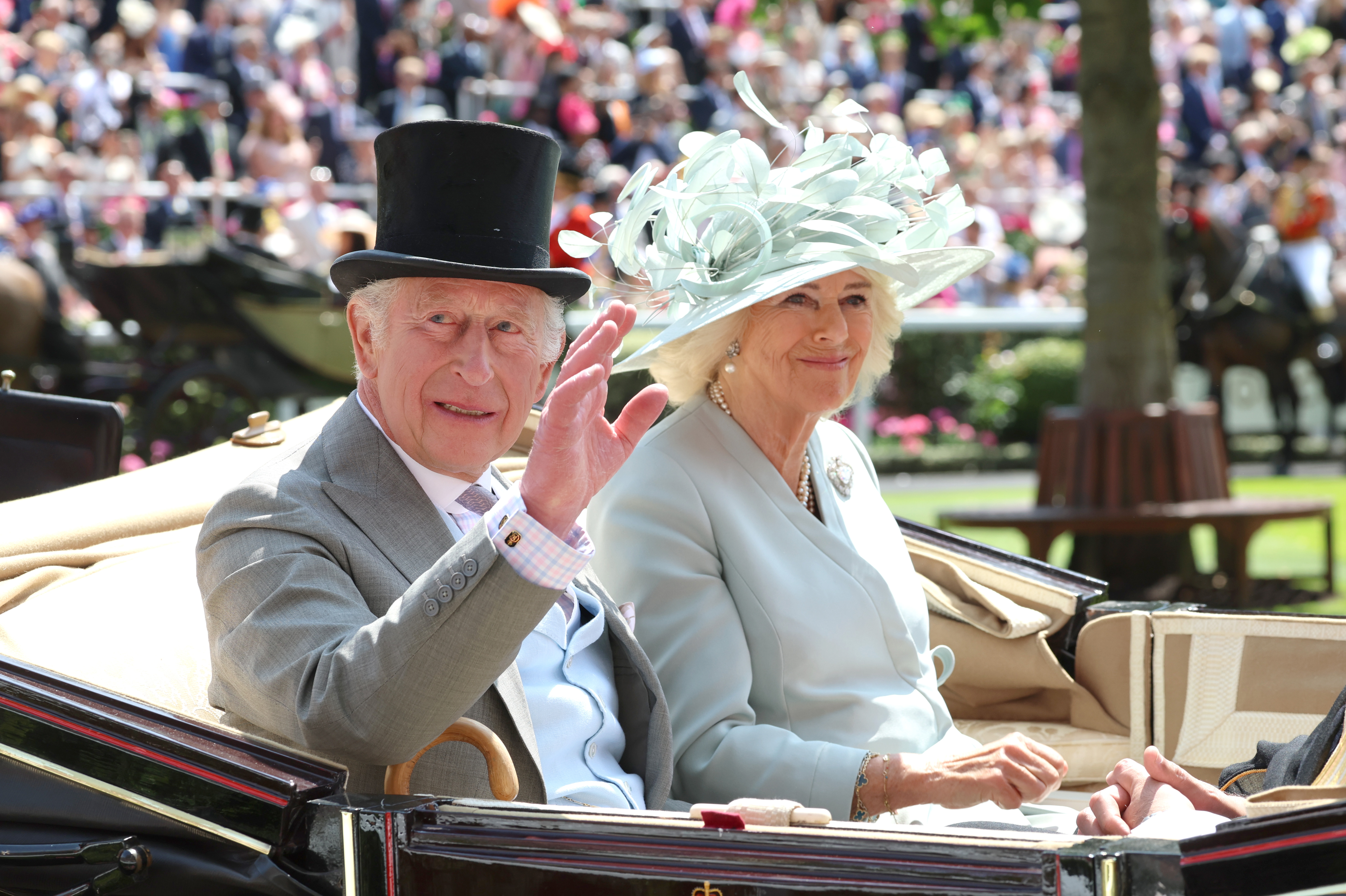 King Charles III and Queen Camilla smiles and wave as they attend day one of Royal Ascot at Ascot Racecourse on June 17, 2025 in Ascot, England | Source: Getty Images