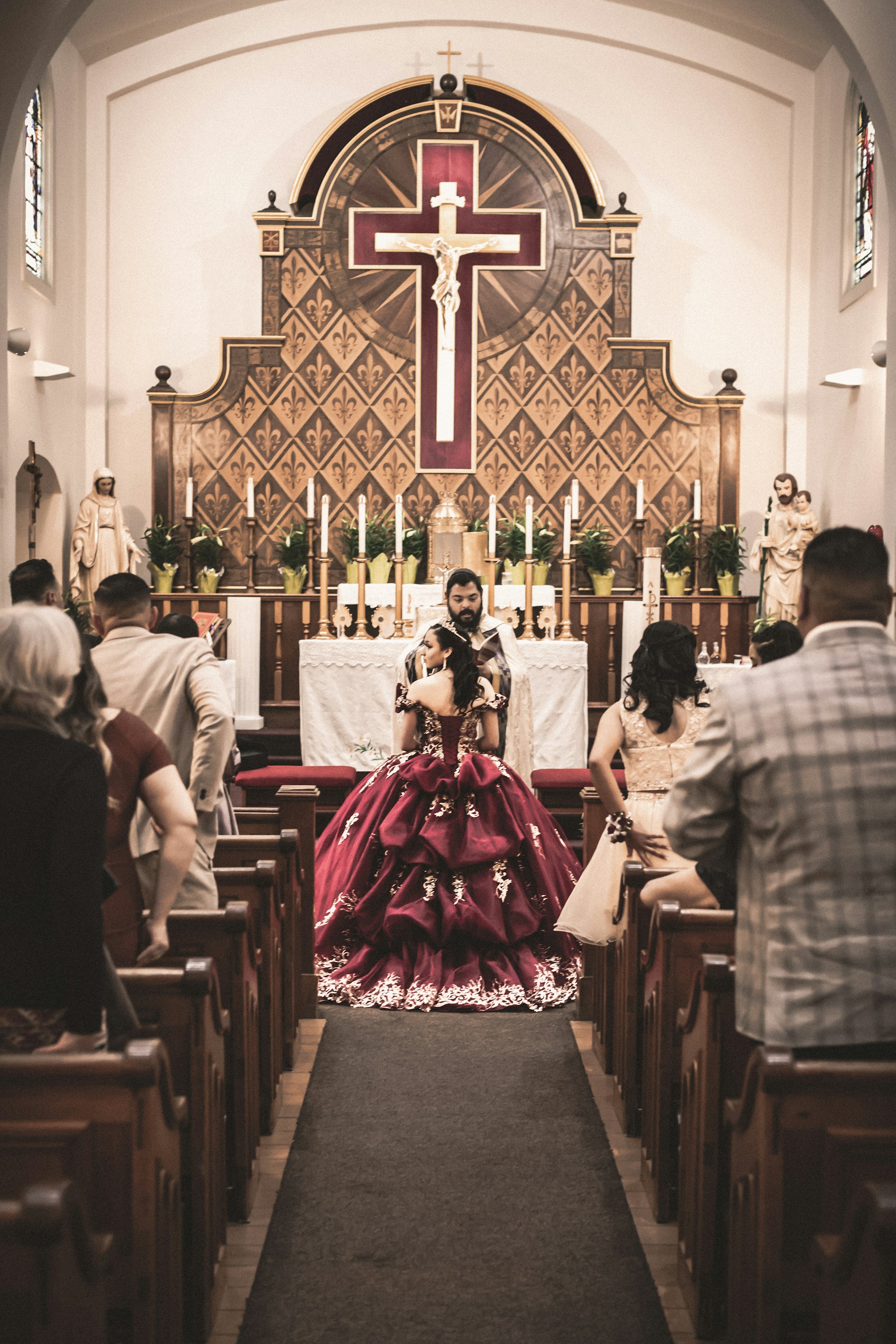 A bride wearing a red and gold gown | Source: Unsplash