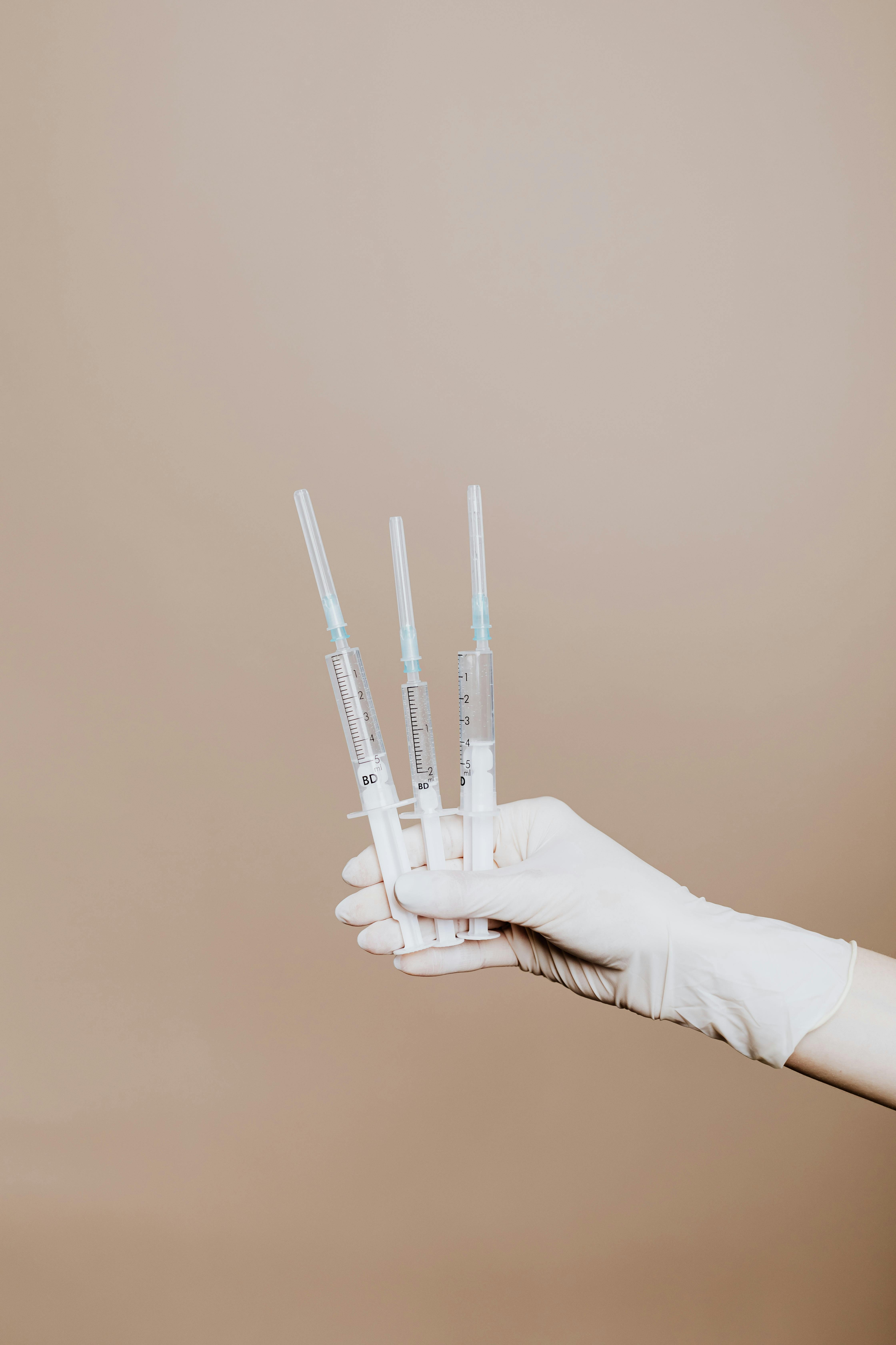 A person holding three syringes | Source: Pexels
