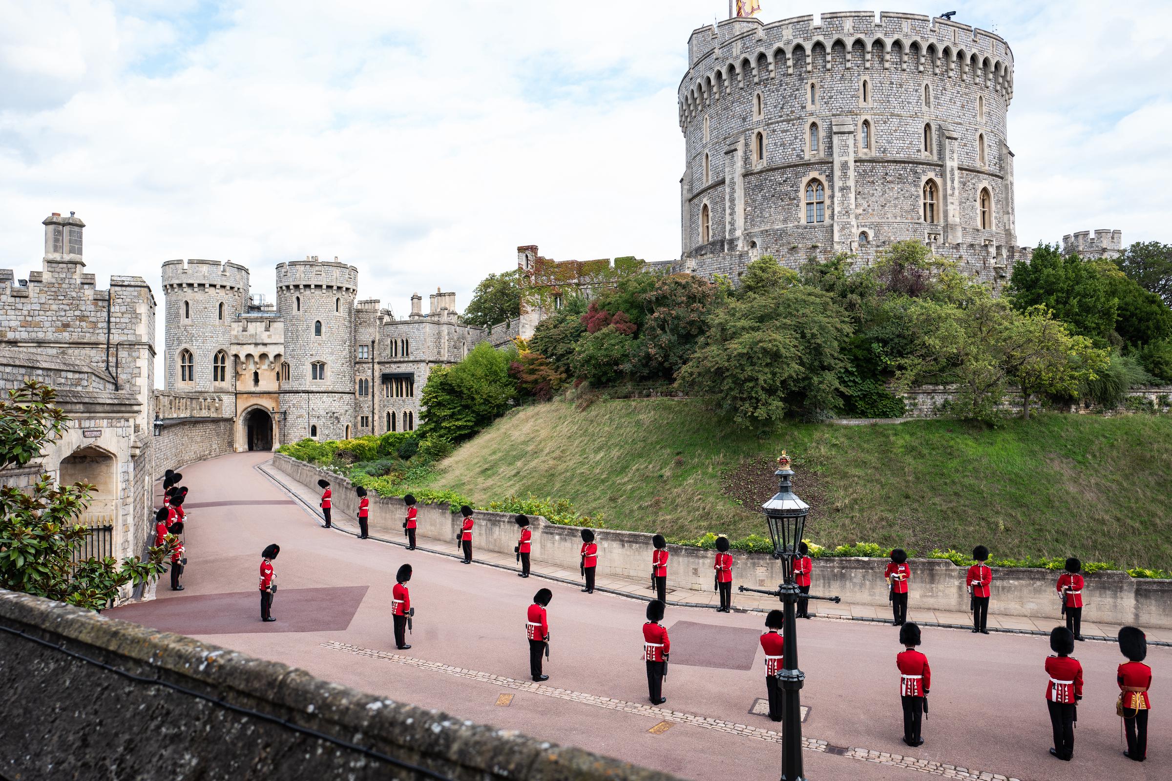 Members of the Armed Forces lower their heads as a mark of respect as they line the road outside the Round Tower ahead of the committal service for Queen Elizabeth II at Windsor Castle on September 19, 2022, in Windsor, England. | Source: Getty Images