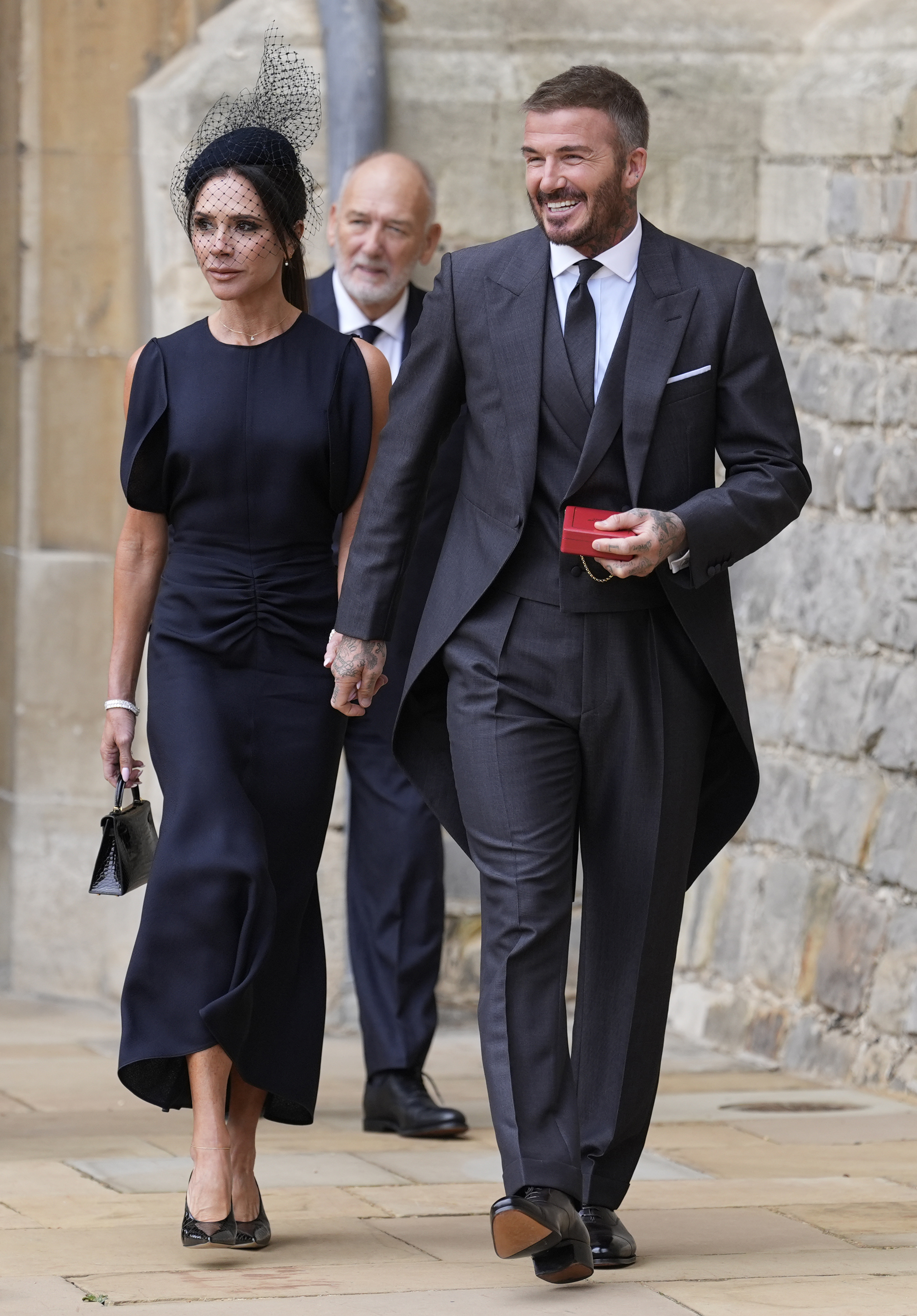 Sir David Beckham walks with his wife, Lady Victoria Beckham, after he was made a Knight Bachelor at an investiture ceremony at Windsor Castle on November 4, 2025, in Windsor, England. | Source: Getty Images