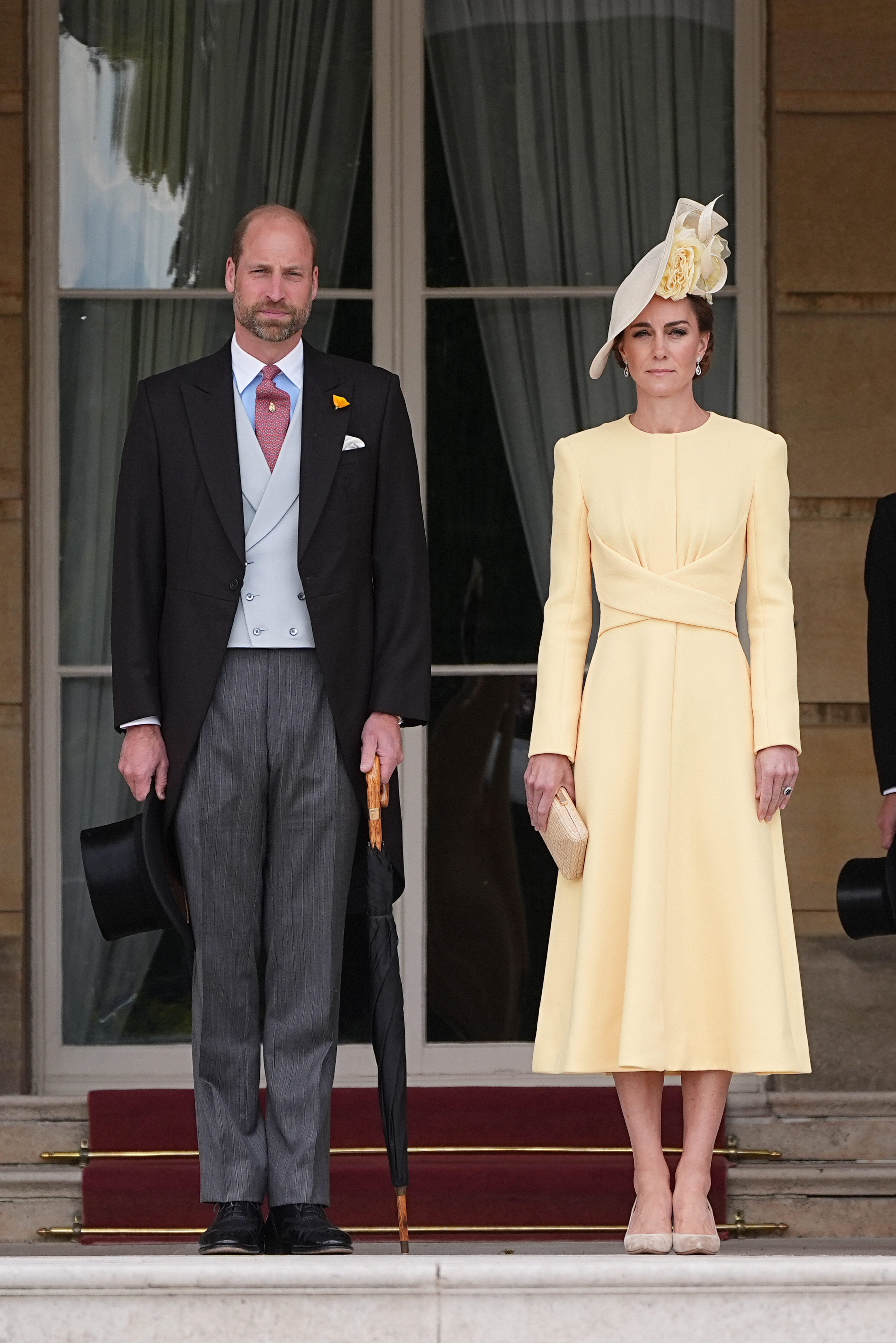 Prince William, Prince of Wales, and Catherine, Princess of Wales, stand at the top of the Garden steps before the start of a Royal Garden Party at Buckingham Palace on May 20, 2025, in London, England. | Source: Getty Images