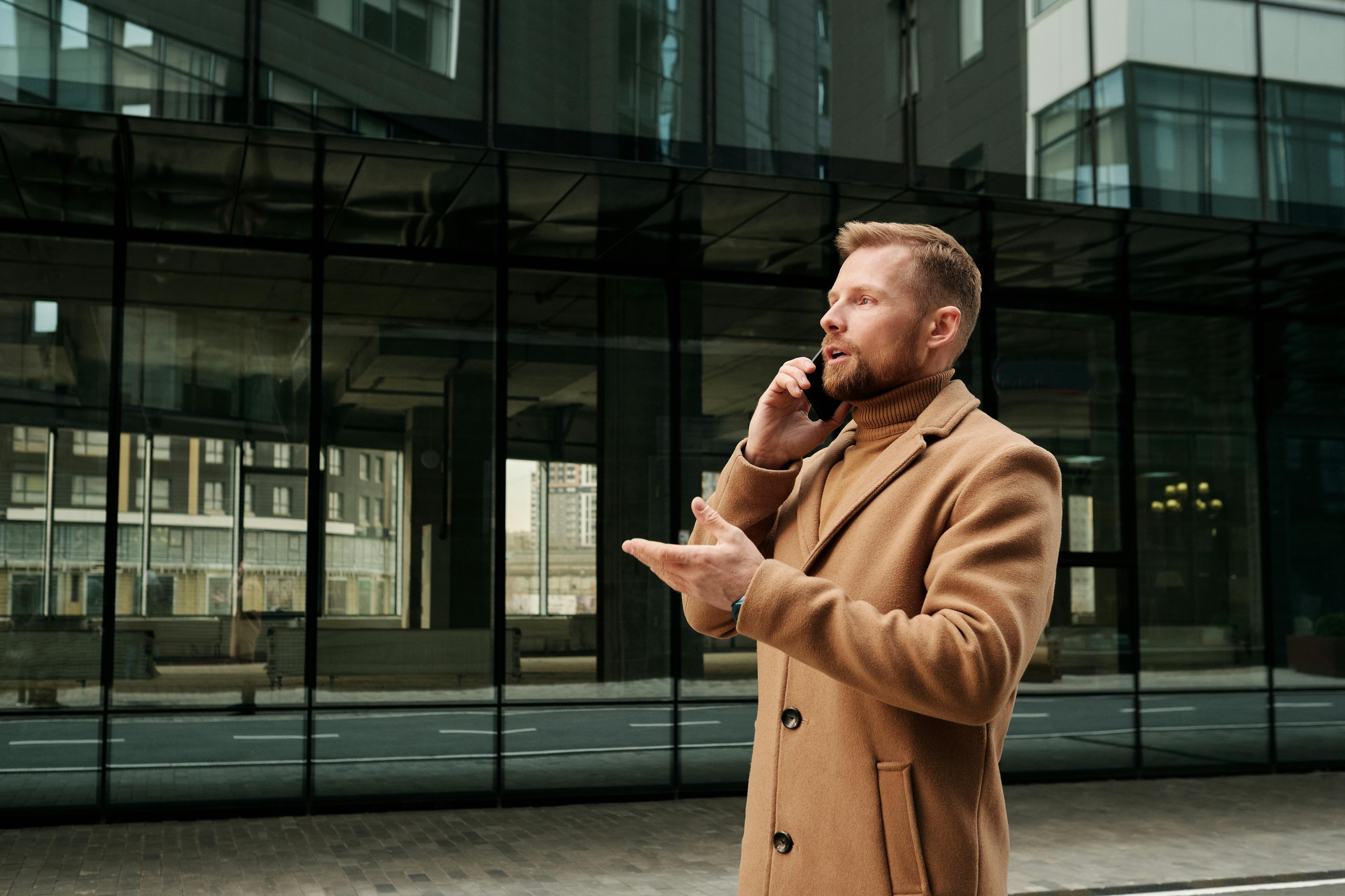 A man standing outside and talking on a phone | Source: Pexels
