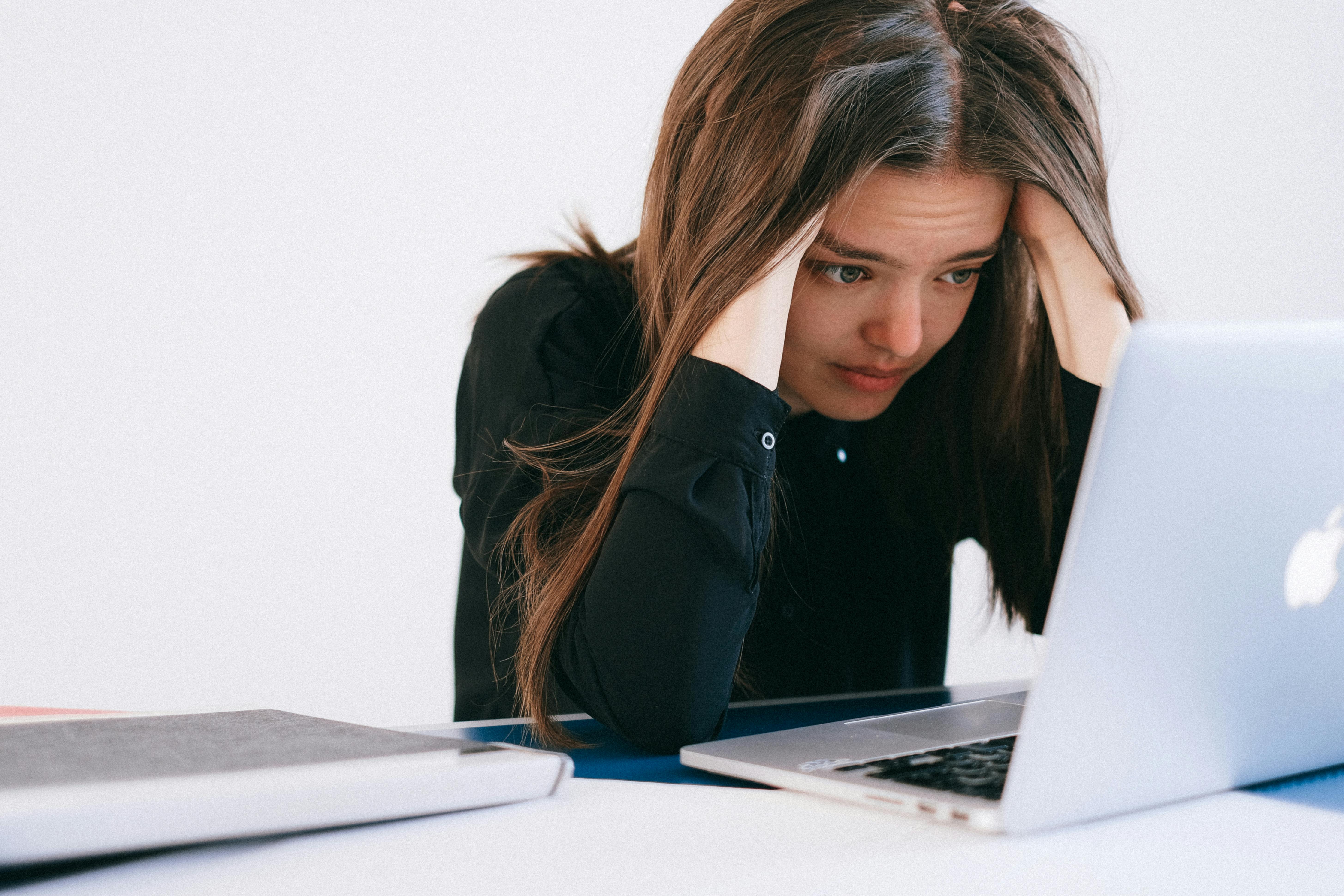 Stressed woman looking at her laptop | Source: Pexels