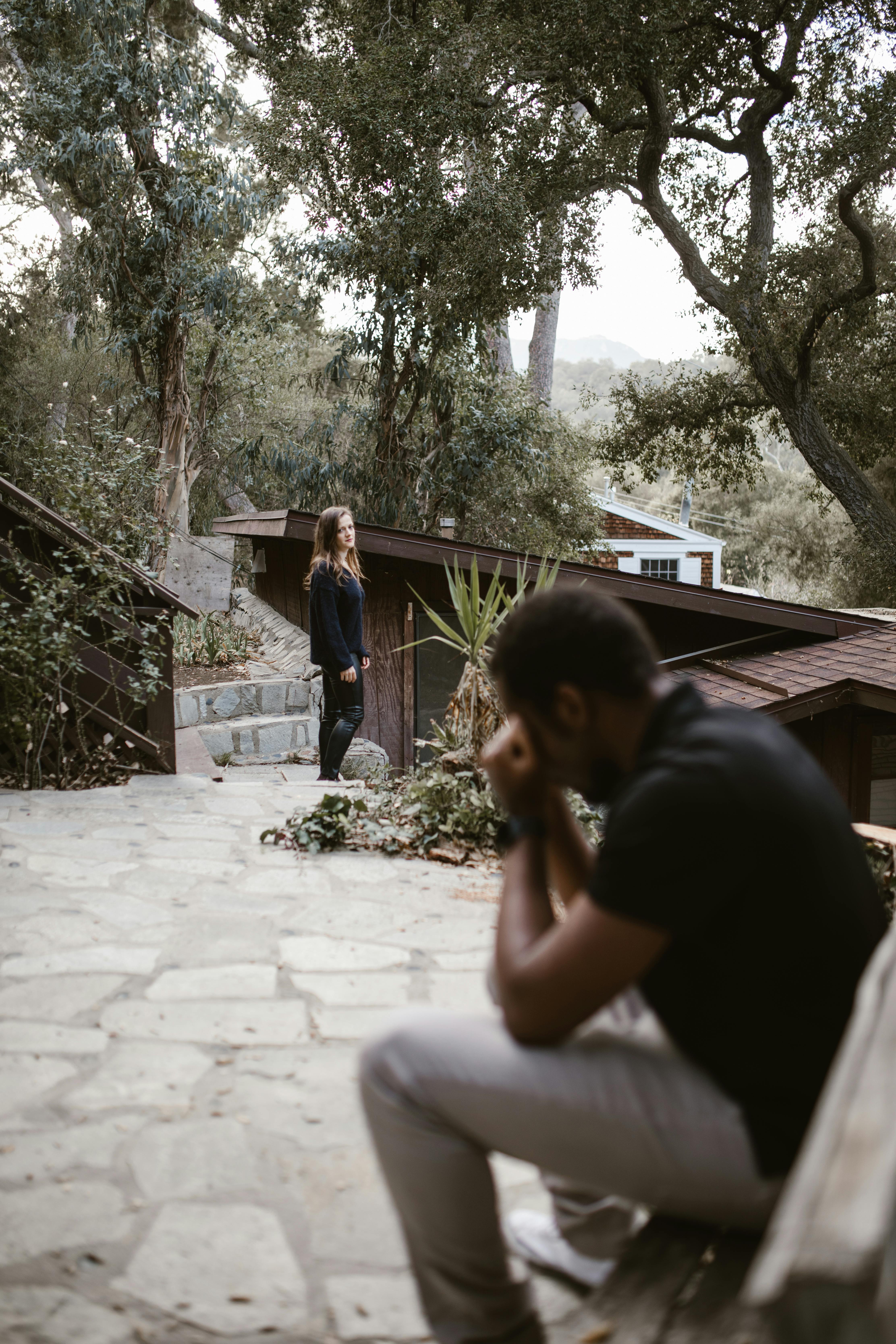 A woman looking at a man sitting on a bench | Source: Pexels