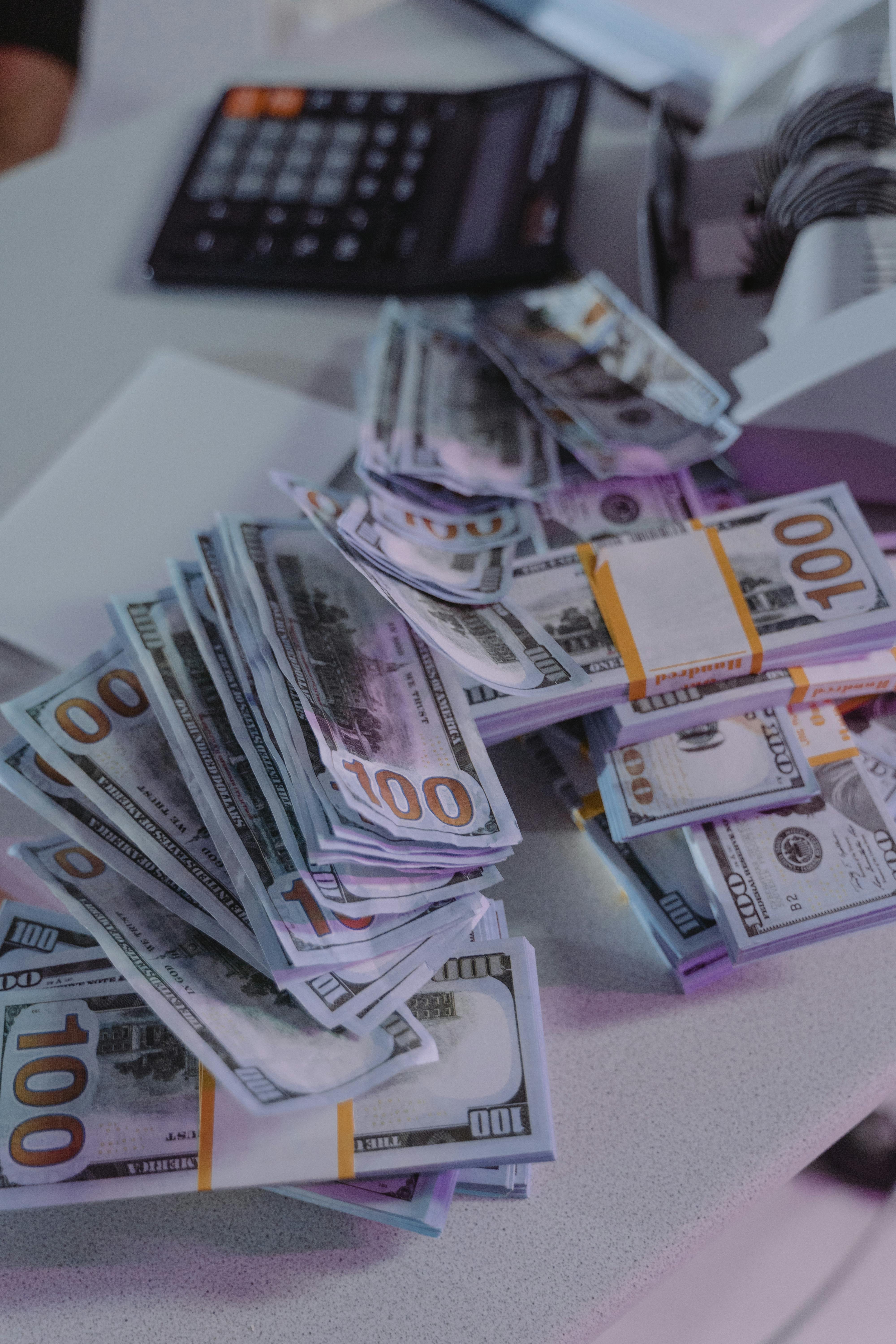 Stacks of money on a counter | Source: Pexels