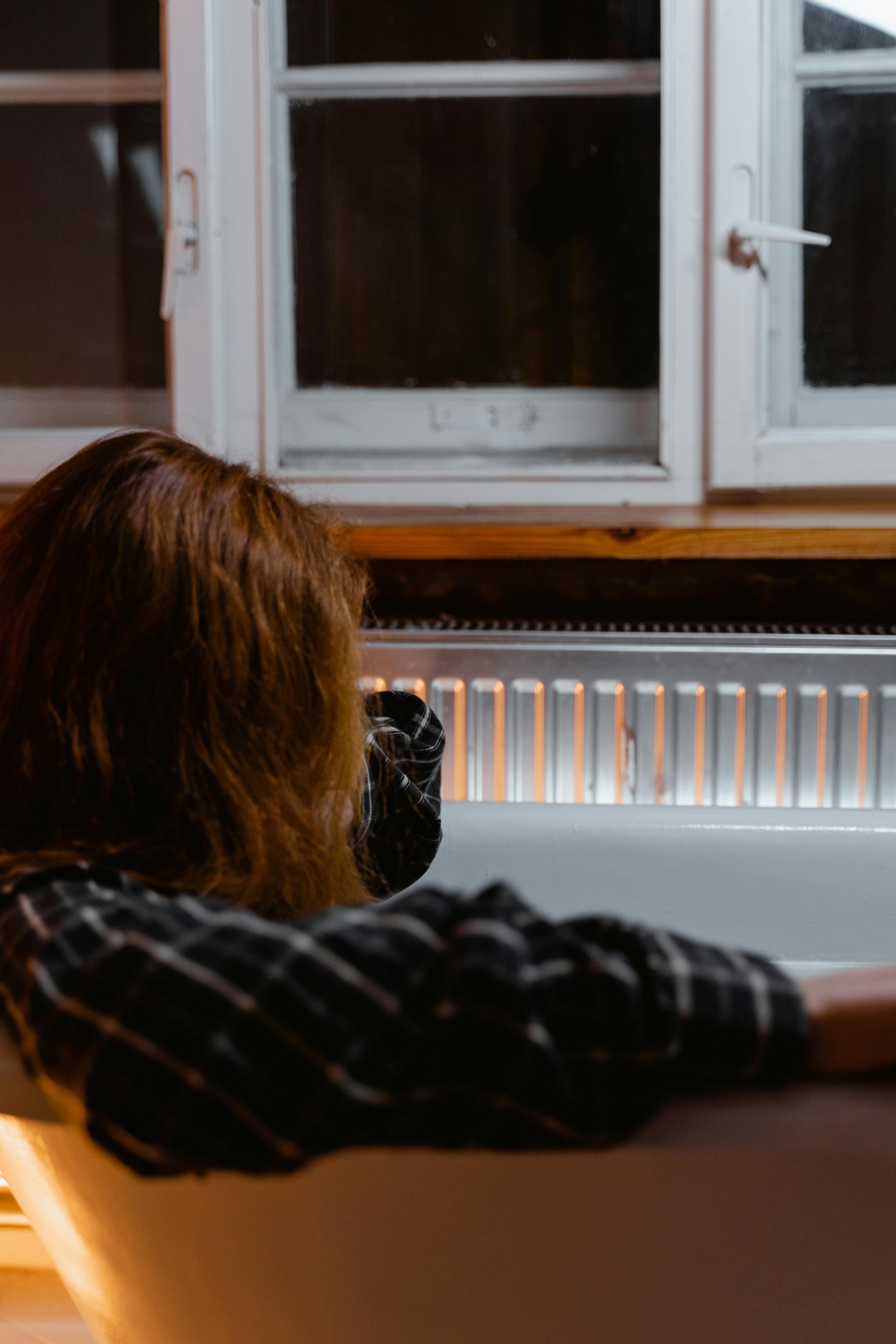 An upset woman sitting in a bathtub | Source: Pexels