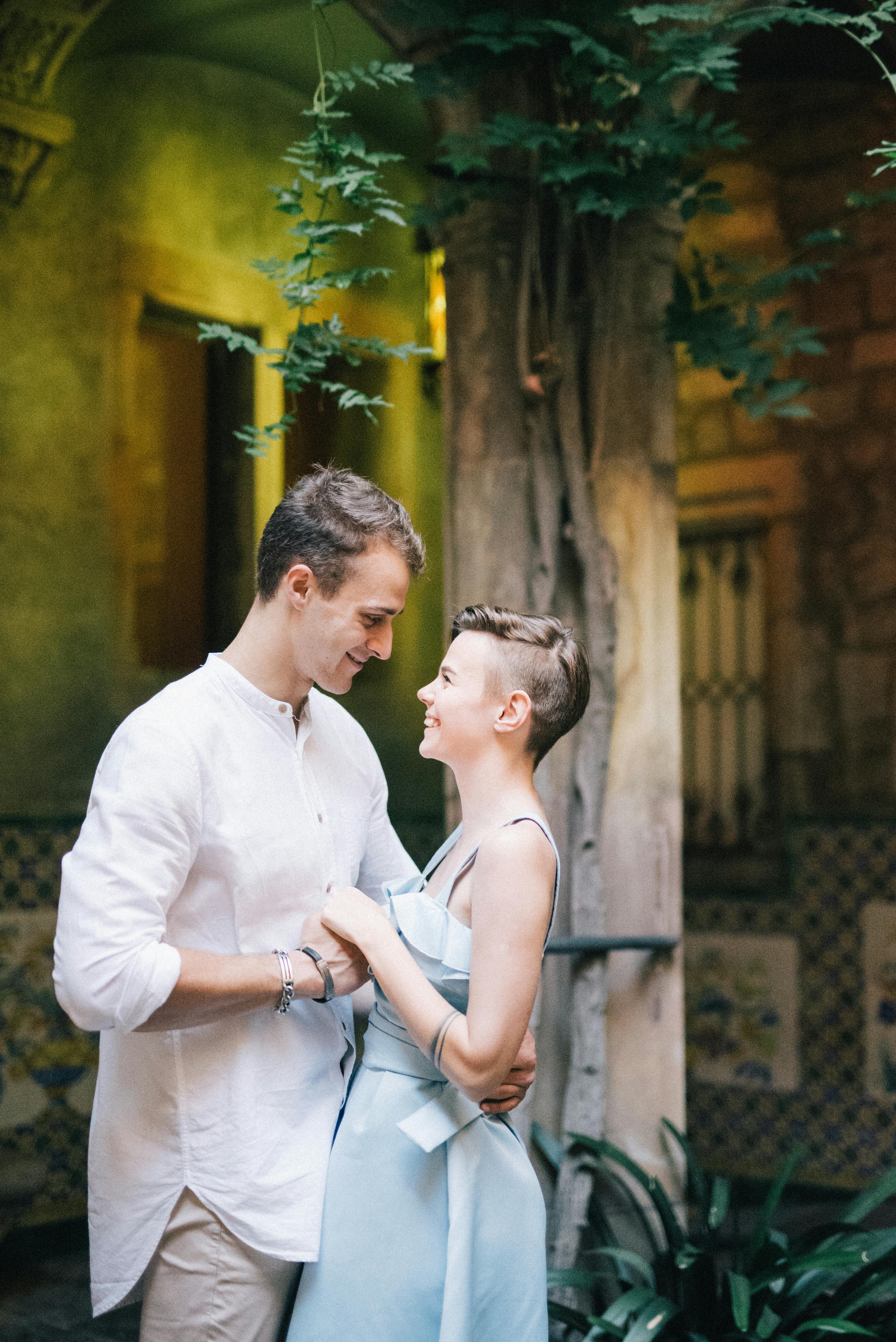 A couple holding hands while looking at each other | Source: Pexels