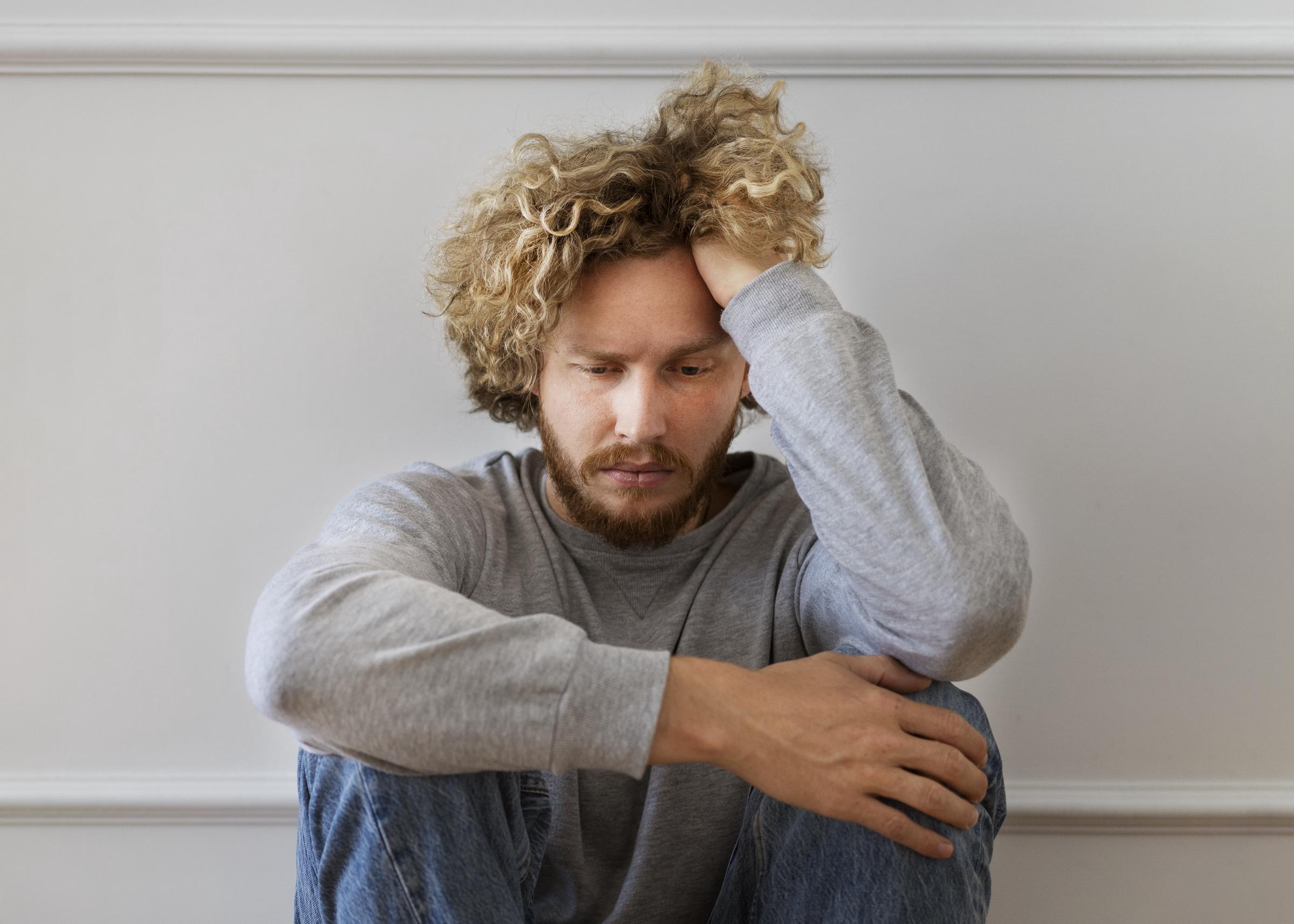 A close up of an upset man wearing a gray sweater | Source: Freepik