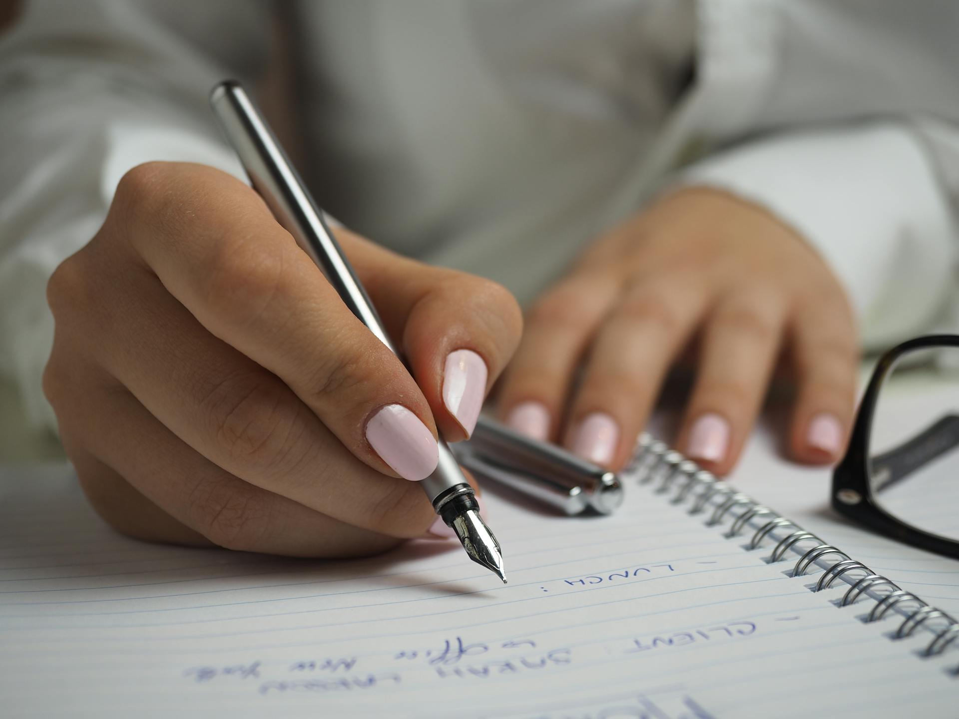 A woman writing | Source: Pexels
