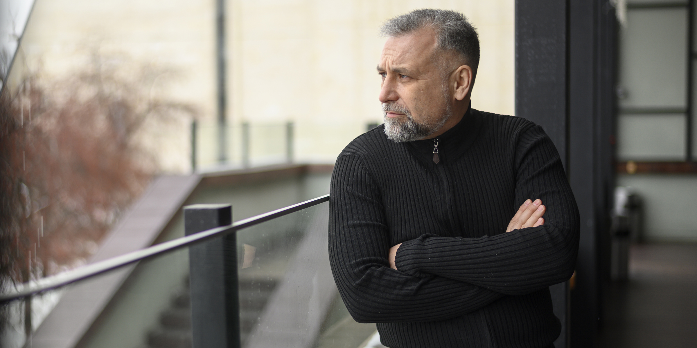 A stern man standing on a balcony | Source: Freepik