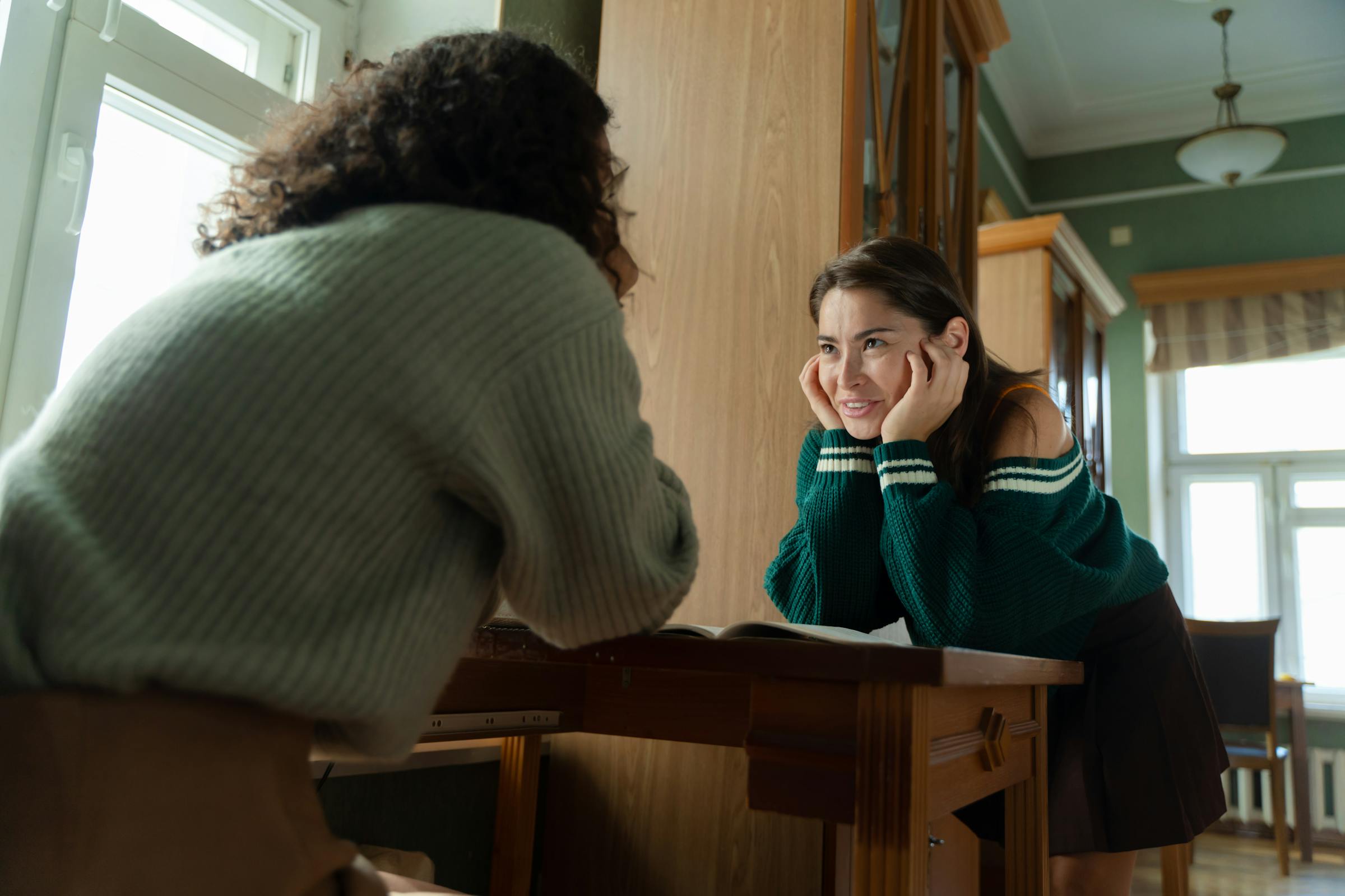 Friends talking in a library | Source: Pexels