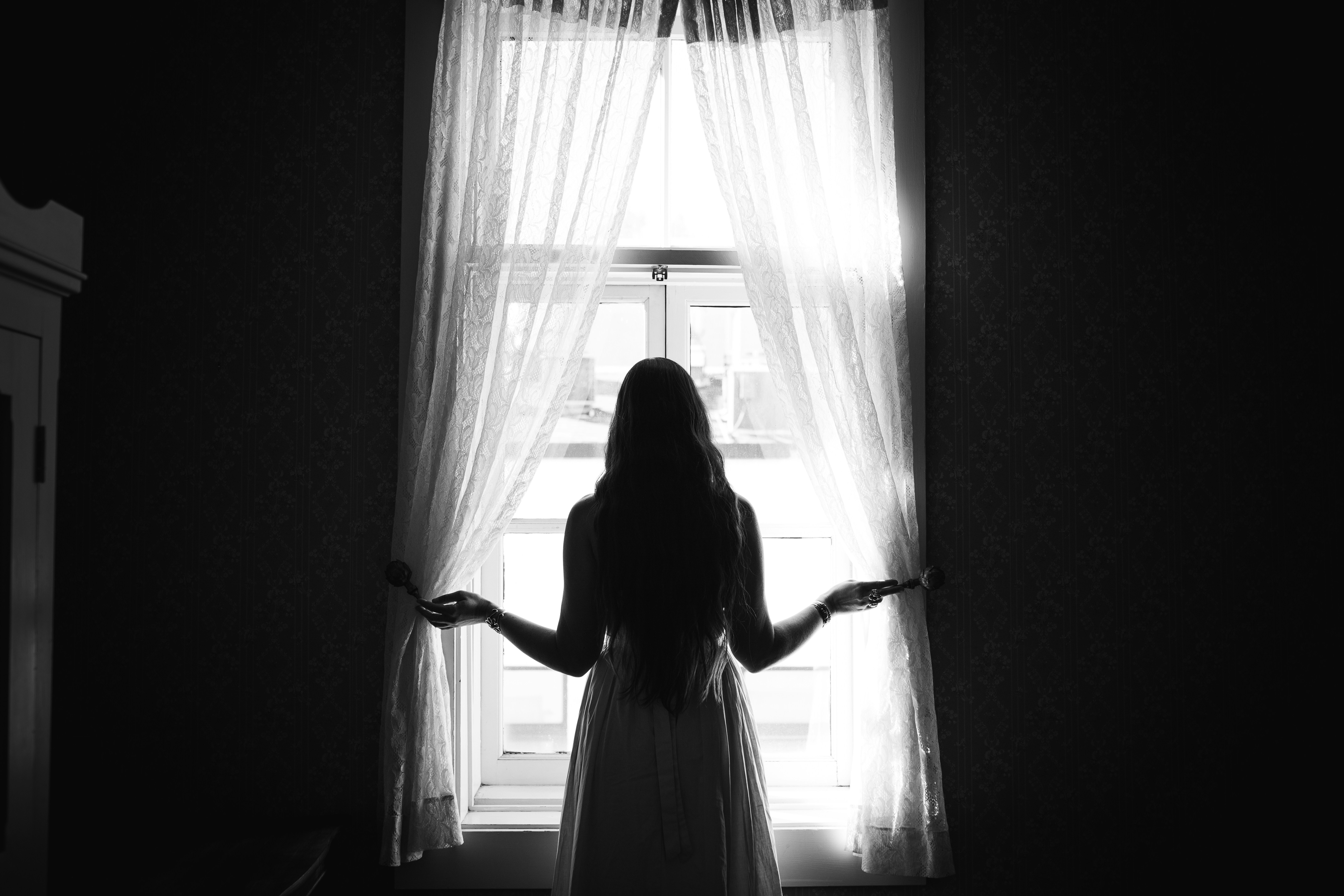 A woman looking out of a window | Source: Unsplash