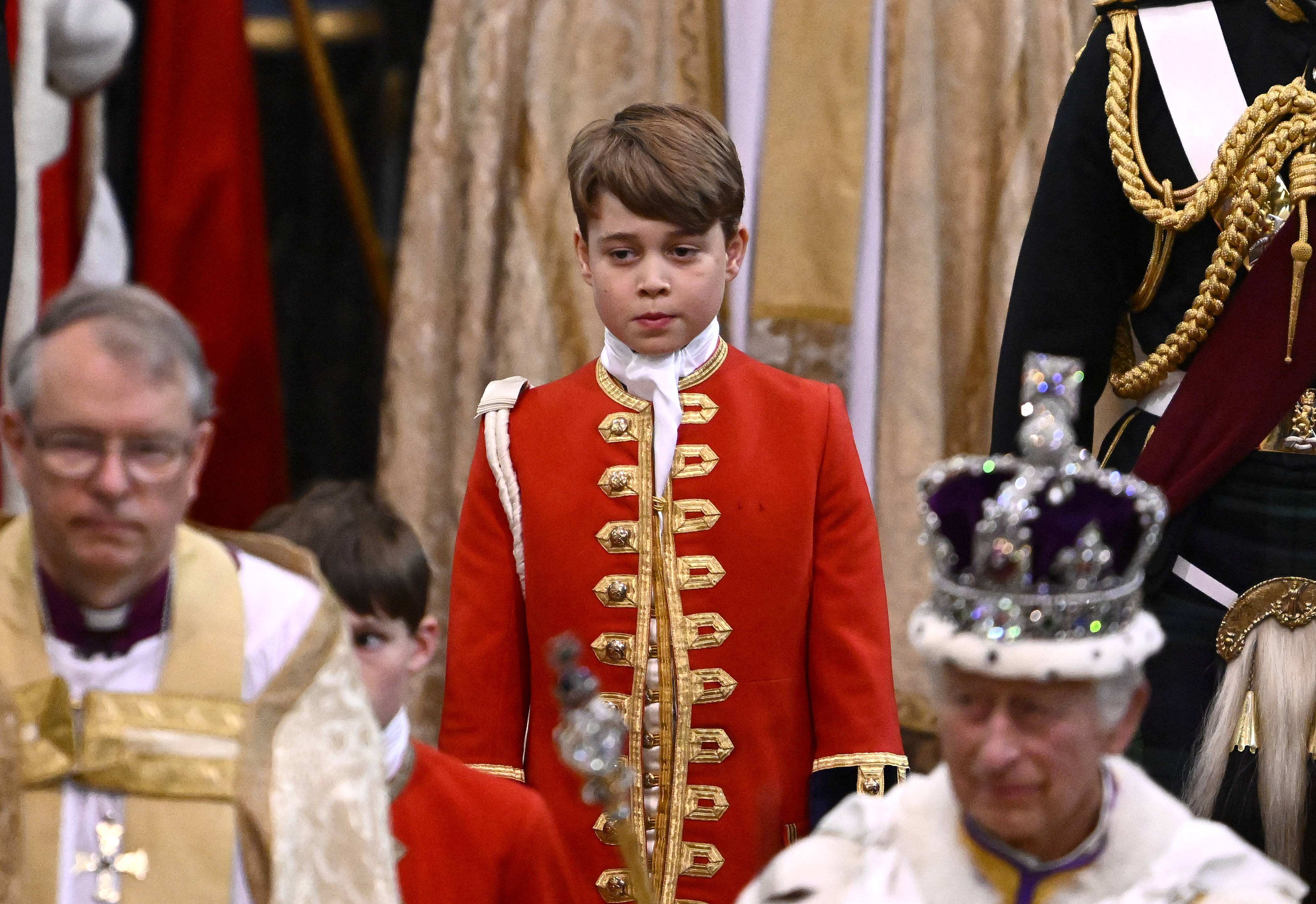 Page of Honour Prince George of Wales and Britain's King Charles III wearing the Imperial state Crown leave Westminster Abbey after the Coronation Ceremonies in central London on May 6, 2023. | Source: Getty Images