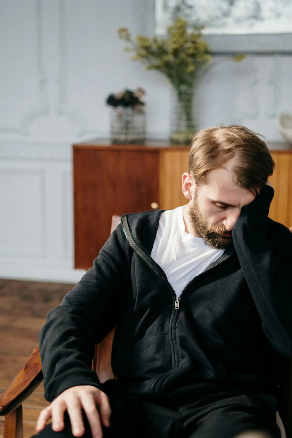 A sad man rubbing his face | Source: Pexels