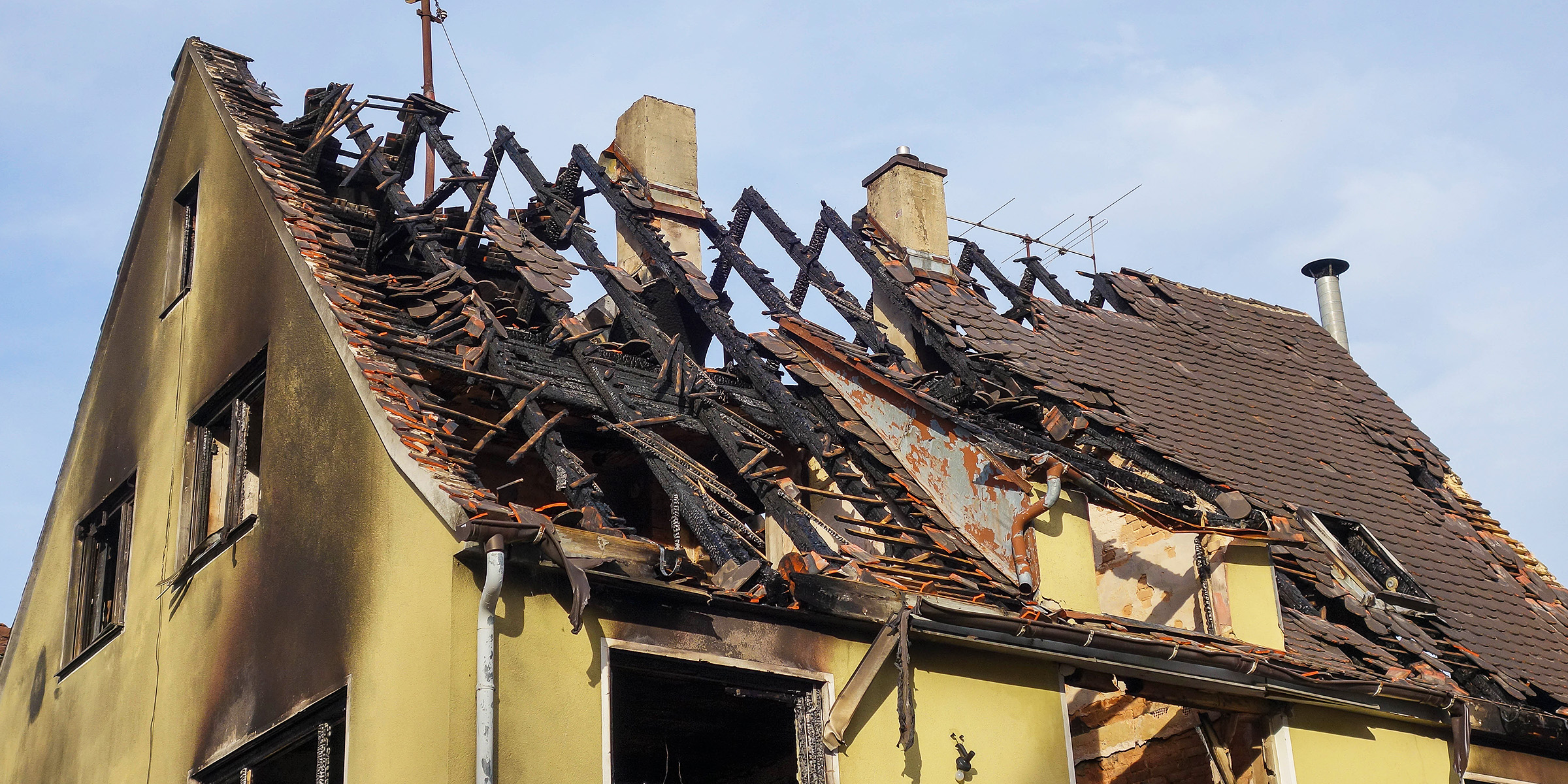 Crumbled rooftop of a partially burned building | Source: Shutterstock