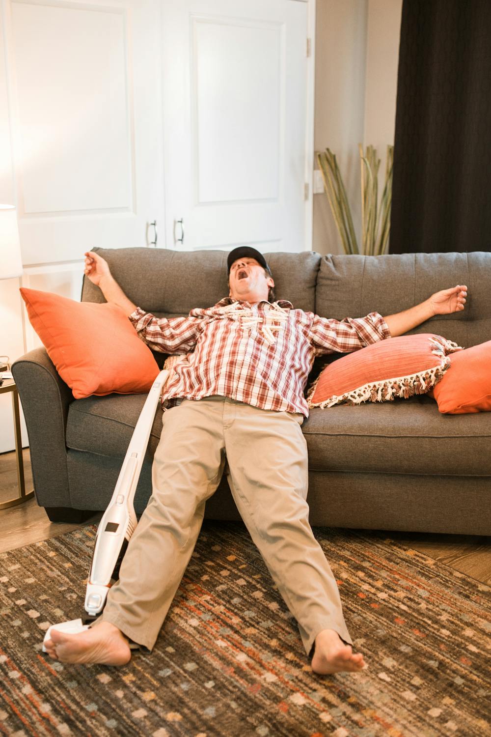 A tired man sleeping on a couch | Source: Pexels