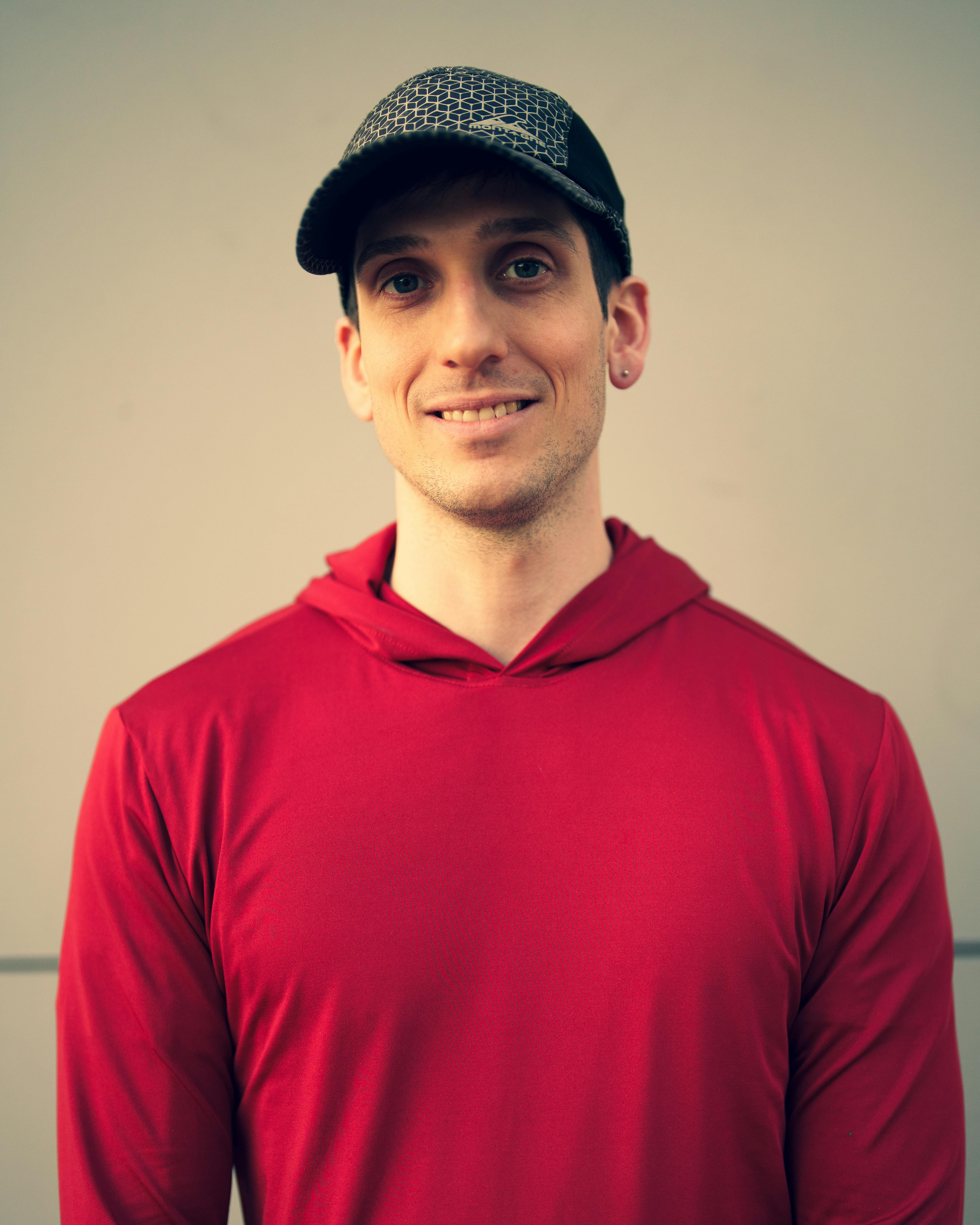 A smiling man in a red hoodie | Source: Pexels