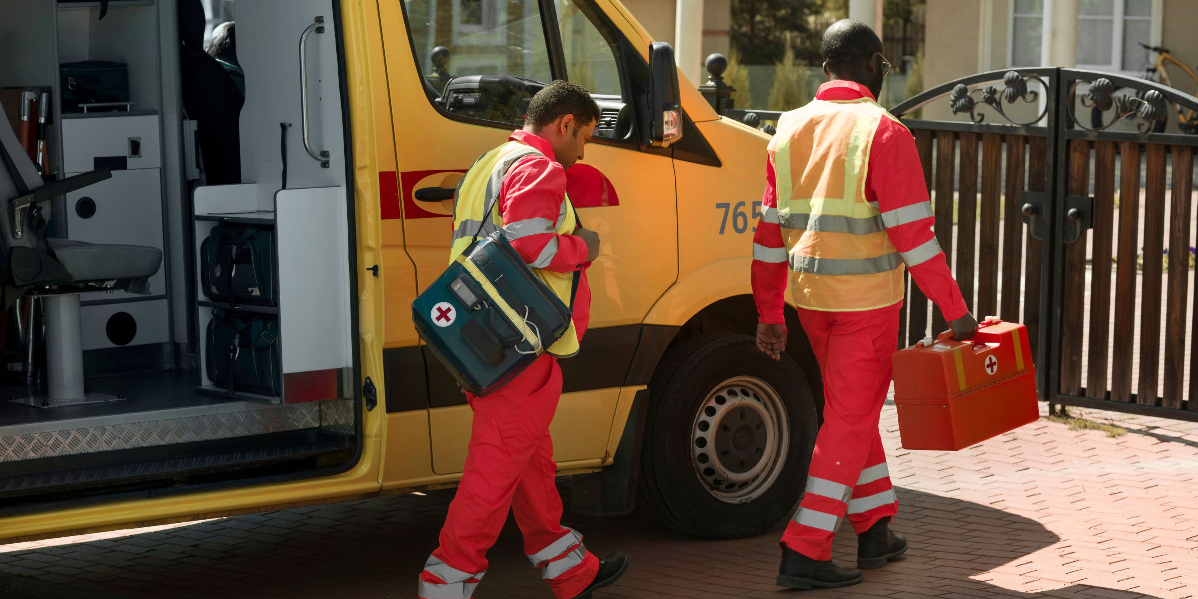 Paramedics walking beside an ambulance | Source: Freepik