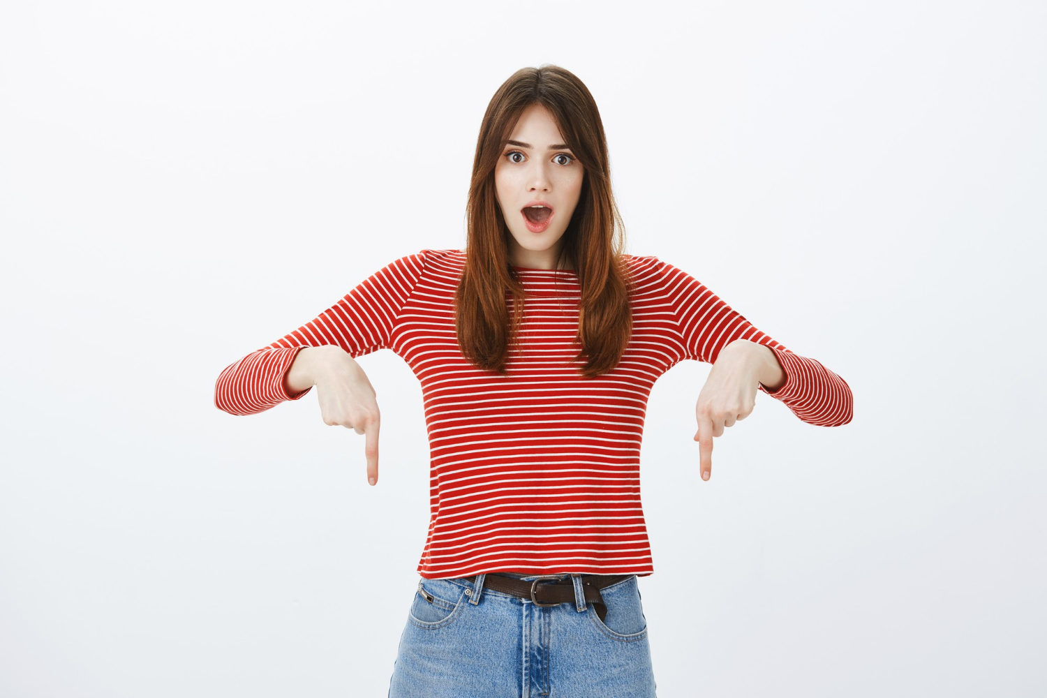 A woman pointing to the floor | Source: Freepik